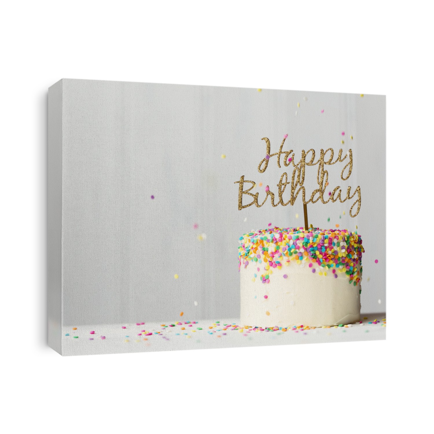 Colorful birthday cake with golden happy birthday banner and falling sprinkles